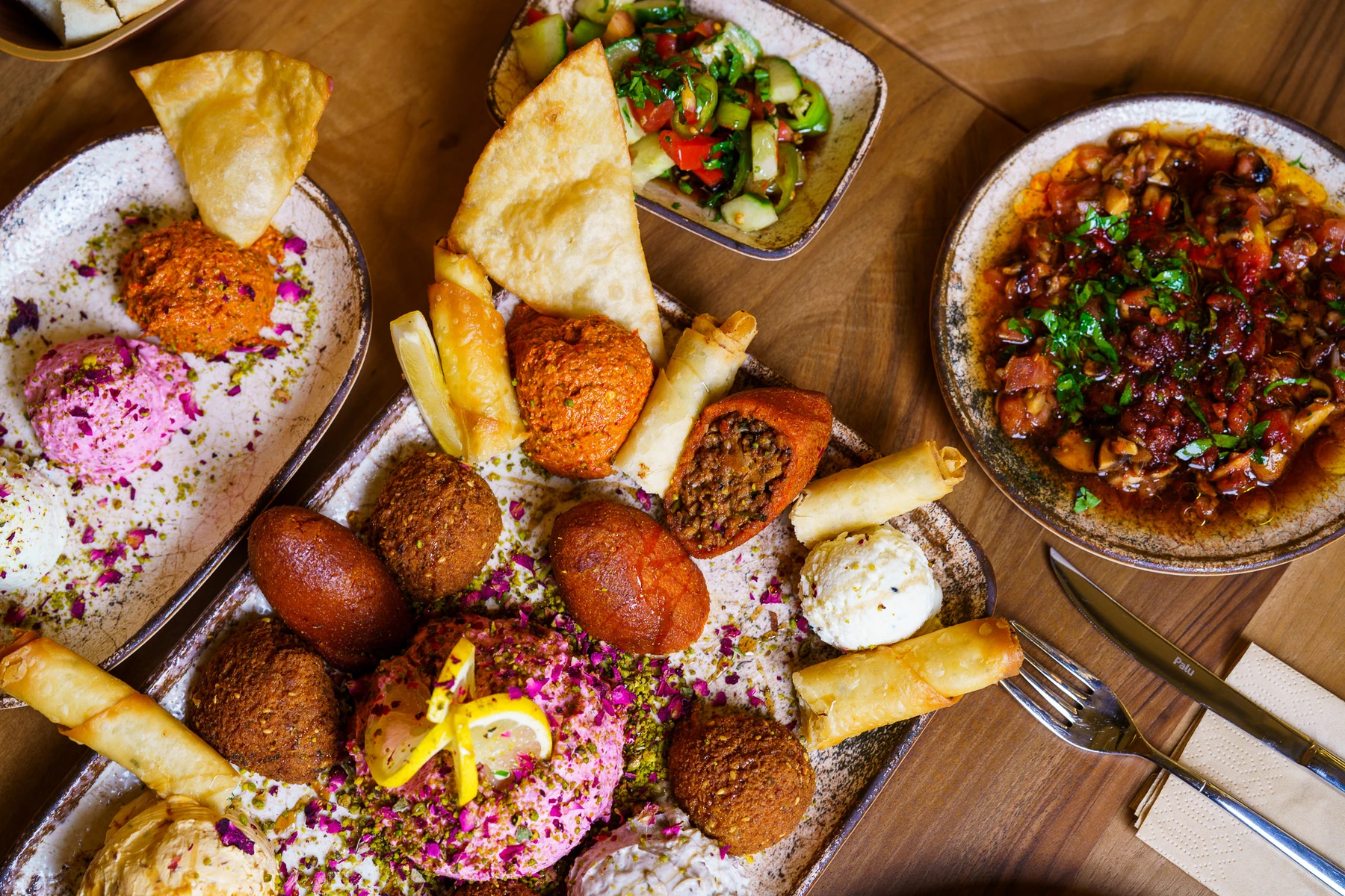 Bread and hot and cold meze on several ceramic plates